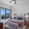 Luxury Apartments For Rent In Atlanta, GA - Mira at Midtown Union - Spacious Bedroom With High Ceiling, Ceiling Fan, Carpet Flooring, And A Window With Views Of Midtown.