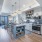 Dog-Friendly Apartments In Atlanta, GA - Mira At Midtown Union - Open-Concept Gourmet Kitchen With Granite Countertops, Built-In Island With Shelving, Accent Tile Backsplash, Custom Pendant Lighting, Stainless Steel GE Appliance Package, White Cabinets, A
